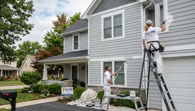 Professional house painters working on exterior home in Champaign, IL